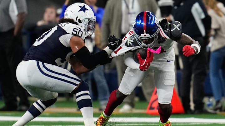 Nov 28, 2024; Arlington, Texas, USA;  New York Giants wide receiver Malik Nabers (1) catches a pass as Dallas Cowboys linebacker Eric Kendricks (50) defends during the second half at AT&T Stadium.  