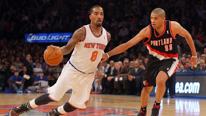 Feb 5, 2014; New York, NY, USA; New York Knicks shooting guard J.R. Smith (8) drives on Portland Trailblazers small forward Nicolas Batum (88) during the third quarter of a game at Madison Square Garden. The Trailblazers defeated the Knicks 94-90. Mandatory Credit: Brad Penner-Imagn Images