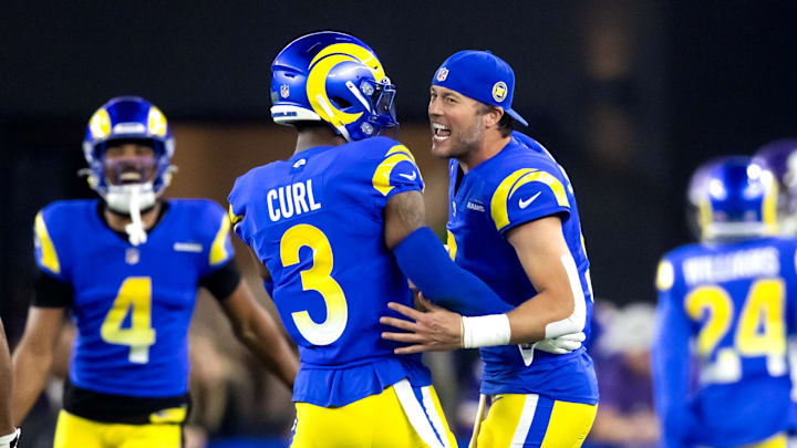 Jan 13, 2025; Glendale, AZ, USA; Los Angeles Rams quarterback Matthew Stafford (9) celebrates a touchdown with safety Kamren Curl (3) against the Minnesota Vikings during an NFC wild card game at State Farm Stadium. Mandatory Credit: Mark J. Rebilas-Imagn Images