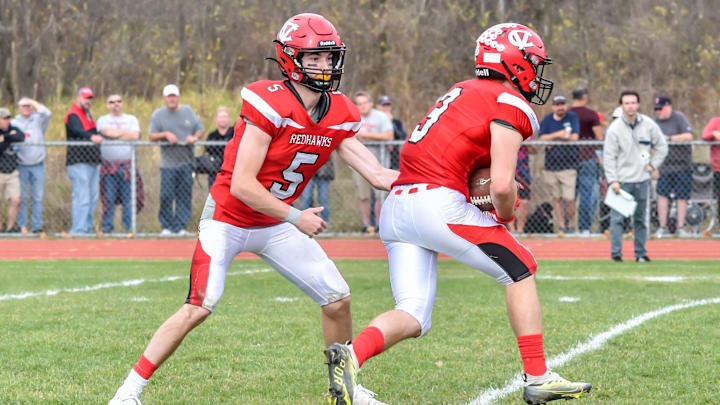 CVU's quarterback, Ollie Cheer hands the ball to Jack Sumner during the Redhawks' D1 football semifinal vs the Essex Hornets on Saturday afternoon in Hinesburg

D1 Football Semifinal Essex At Cvu 05nov22 9004