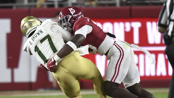 Sep 7, 2024; Tuscaloosa, Alabama, USA;  Alabama Crimson Tide linebacker Justin Jefferson (15) tackles South Florida Bulls quarterback Byrum Brown (17) at Bryant-Denny Stadium. Jefferson was called for targeting on the play. Alabama won 42-16. Mandatory Credit: Gary Cosby Jr.-Imagn Images