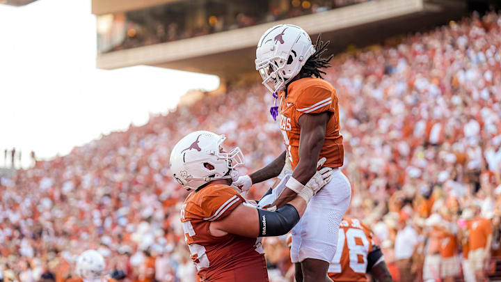 Sep 28, 2024; Austin, Texas, USA;  Texas Longhorns center Jake Majors (65) celebrates a touchdown by receiver DeAndre Moore Jr. (7) during a game the against Mississippi State Bulldogs at Darrell K Royal-Texas Memorial Stadium. Mandatory Credit: Aaron E. Martinez/USA TODAY Network via Imagn Images
