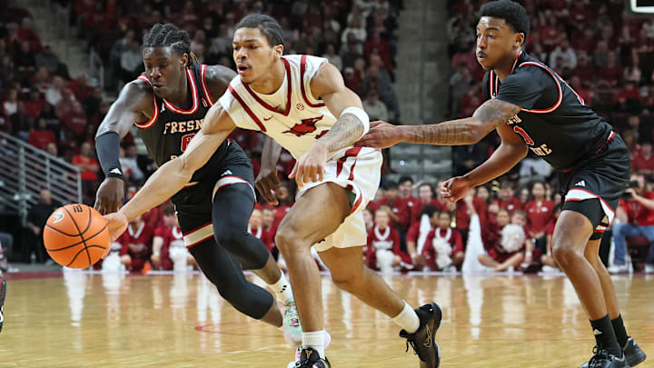 Dec 6, 2025; North Little Rock, Arkansas, USA; Arkansas Razorbacks guard Darius Acuff Jr (5) reaches for the ball between Fresno State Bulldogs guards DJ Stickman (6) and Zaon Collins (10) during the second half at Simmons Bank Arena. Arkansas won 82-58. Dec 6, 2025; North Little Rock, Arkansas, USA; Arkansas Razorbacks guard Darius Acuff Jr (5) reaches for the ball between Fresno State Bulldogs guards DJ Stickman (6) and Zaon Collins (10) during the second half at Simmons Bank Arena. Arkansas won 82-58.