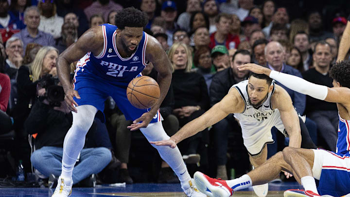 Jan 25, 2023; Philadelphia, Pennsylvania, USA; Brooklyn Nets guard Ben Simmons (10) and Philadelphia 76ers center Joel Embiid (21) scramble for a loose ball during the third quarter at Wells Fargo Center. Mandatory Credit: Bill Streicher-Imagn Images
