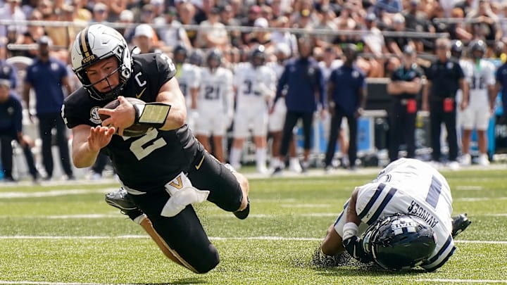 Vanderbilt quarterback Diego Pavia (2) runs in a touchdown past Utah State cornerback Noah Avinger (1) during the second quarter at FirstBank Stadium in Nashville, Tenn., Saturday, Sept. 27, 2025.