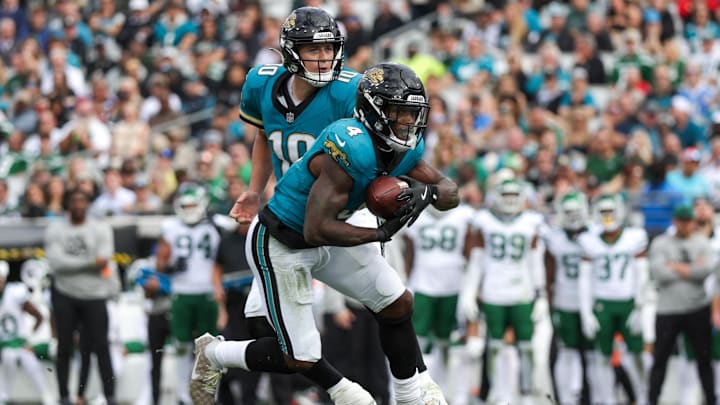 Dec 15, 2024; Jacksonville, Florida, USA; Jacksonville Jaguars quarterback Mac Jones (10) hands off to Jacksonville Jaguars running back Tank Bigsby (4) against the New York Jets in the second quarter at EverBank Stadium. Mandatory Credit: Nathan Ray Seebeck-Imagn Images