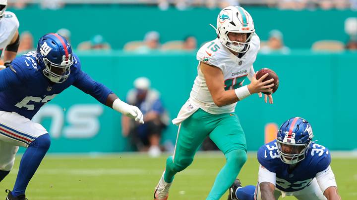 Miami Dolphins quarterback Cam Miller (15) runs with the football against New York Giants linebacker Caleb Murphy (33) and defensive tackle Marlon Davidson (67) during the first half at Hard Rock Stadium. Miami Dolphins quarterback Cam Miller (15) runs with the football against New York Giants linebacker Caleb Murphy (33) and defensive tackle Marlon Davidson (67) during the first half at Hard Rock Stadium.