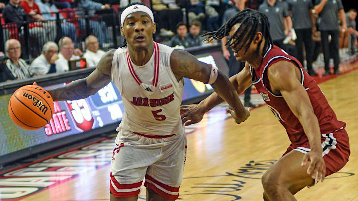 Jax StateÕs Jaron Pierre Jr. drives to the basket as New Mexico StateÕs Jaden Harris defends during college basketball action in Jacksonville, Alabama February 20, 2025. Jax State fell to New Mexico State 61-52. (Dave Hyatt / Hyatt Media LLC)