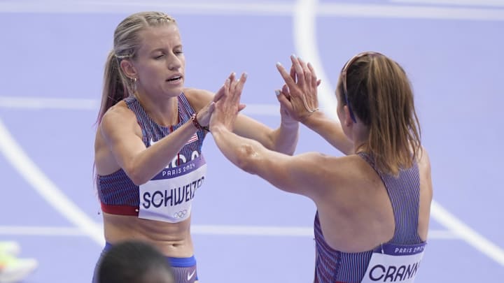Aug 2, 2024; Paris, FRANCE; Elise Cranny (USA) and Karissa Schweizer (USA) react after the women's 5000m round 1 during the Paris 2024 Olympic Summer Games at Stade de France. Mandatory Credit: Andrew Nelles-USA TODAY Sports