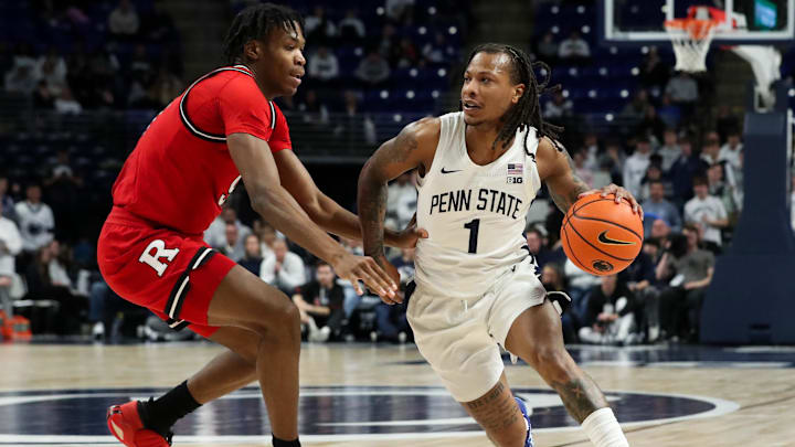 Penn State Nittany Lions guard Ace Baldwin Jr. dribbles the ball around the outside of Rutgers Scarlet Knights forward Dylan Grant during the first half at Bryce Jordan Center.