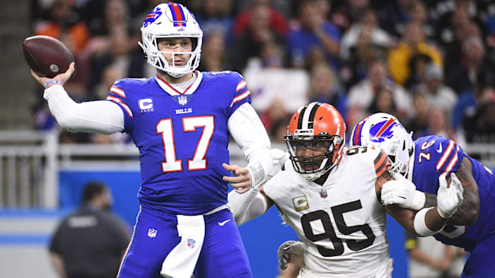 Buffalo Bills quarterback Josh Allen drops back to throw as Cleveland Browns defensive end Myles Garrett pursues.