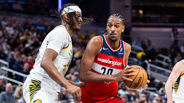 Apr 8, 2025; Indianapolis, Indiana, USA; Washington Wizards forward Alex Sarr (20) dribbles the ball while Indiana Pacers center Myles Turner (33)  defends in the second half at Gainbridge Fieldhouse. Mandatory Credit: Trevor Ruszkowski-Imagn Images