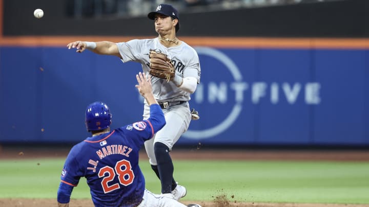 Jun 26, 2024; New York City, New York, USA;  New York Yankees second baseman Oswaldo Cabrera (95) throws past New York Mets designated hitter J.D. Martinez (28) attempting to complete a double play in the third inning at Citi Field. Mandatory Credit: Wendell Cruz-USA TODAY Sports