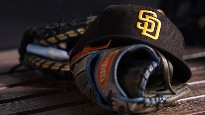 A general view of a San Diego Padres hat and glove in the dugout prior to the game between the Miami Marlins and the San Diego Padres at loanDepot Park in Miami on July 23, 2021. A general view of a San Diego Padres hat and glove in the dugout prior to the game between the Miami Marlins and the San Diego Padres at loanDepot Park in Miami on July 23, 2021.