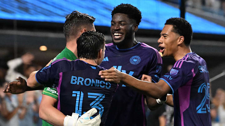 Jul 31, 2024; Charlotte, North Carolina, USA; Charlotte FC goalkeeper David Bingham (22) celebrates with midfielder Brandt Bronico (13) and forward Patrick Agyemang (33) and forward Tyger Smalls (25) after stopping a penalty kick to win the game. Charlotte FC defeated Cruz Azul in a penalty shootout at Bank of America Stadium. Mandatory Credit: Bob Donnan-USA TODAY Sports