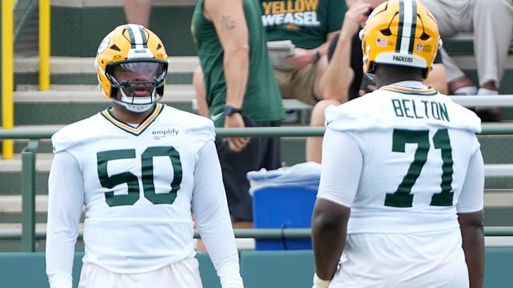 Green Bay Packers offensive tackle Zach Tom (50) and offensive tackle Anthony Belton (71) run through a drill during the second day of training camp on Thursday, July 24, 2025, at Ray Nitschke Field in Ashwaubenon, Wis.