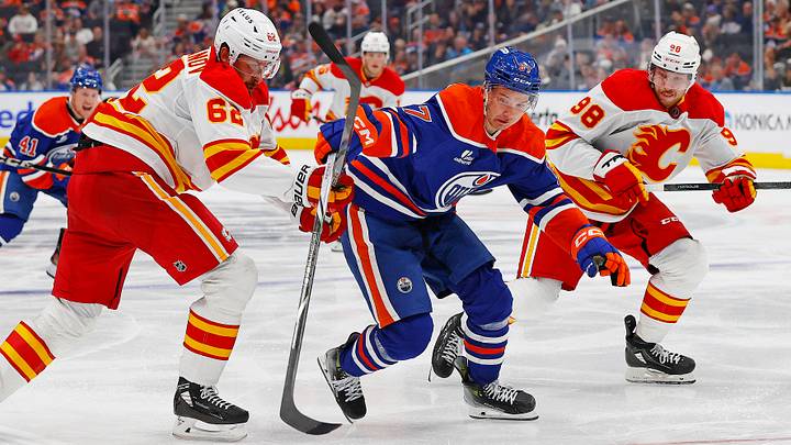 Sep 21, 2025; Edmonton, Alberta, CAN; Edmonton Oilers forward Viljami Marjala (57) carries the puck past Calgary Flames defensemen Daniil Miromanov (62) during the third period Edmonton Oilers at Rogers Place. Mandatory Credit: Perry Nelson-Imagn Images