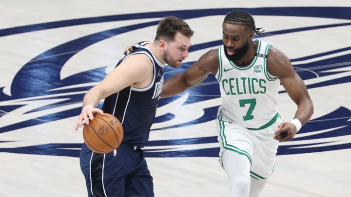 Jun 14, 2024; Dallas, Texas, USA; Dallas Mavericks guard Luka Doncic (77) dribbles against Boston Celtics guard Jaylen Brown (7) during the first half of game four of the 2024 NBA Finals at American Airlines Center. Mandatory Credit: Kevin Jairaj-USA TODAY Sports