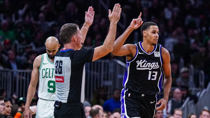 Jan 10, 2025; Boston, Massachusetts, USA; Sacramento Kings forward Keegan Murray (13) reacts after his three point basket against Boston Celtics guard Derrick White (9) in the second half at TD Garden. Mandatory Credit: David Butler II-Imagn Images