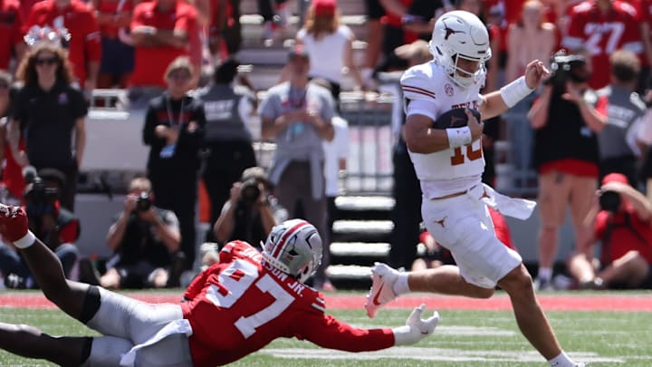 Aug 30, 2025; Columbus, Ohio, USA; Texas Longhorns quarterback Arch Manning (16) rushes the ball past Ohio State Buckeyes defensive end Kenyatta Jackson Jr. (97) in the first half.