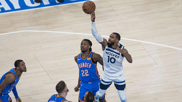 Minnesota Timberwolves guard Mike Conley shoots against Oklahoma City Thunder guard Cason Wallace (22) in the fourth quarter during Game 2 of the Western Conference finals at Paycom Center in Oklahoma City on May 22, 2025.