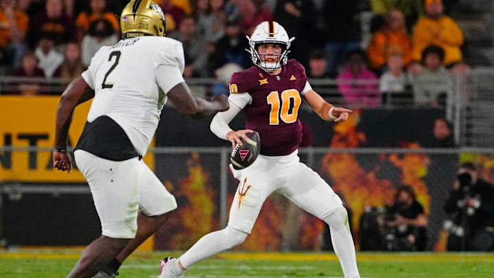 ASU quarterback Sam Leavitt (10) looks for receivers against UCF defensive lineman Kobe Hudson (2) during a game at Mountain America Stadium in Tempe on Nov. 9, 2024.