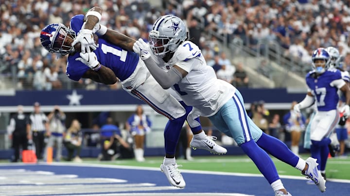 Sep 14, 2025; Arlington, Texas, USA; New York Giants wide receiver Malik Nabers (1) makes a catch for a touchdown against Dallas Cowboys cornerback Trevon Diggs (7) during the second quarter at AT&T Stadium. Mandatory Credit: Kevin Jairaj-Imagn Images