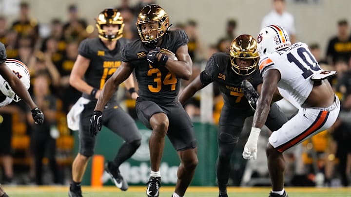 Aug 29, 2025; Waco, Texas, USA;  Baylor Bears wide receiver Josh Cameron (34) carries the ball as Auburn Tigers defensive end Amaris Williams (10) defends during the second half at McLane Stadium. Mandatory Credit: Chris Jones-Imagn Images