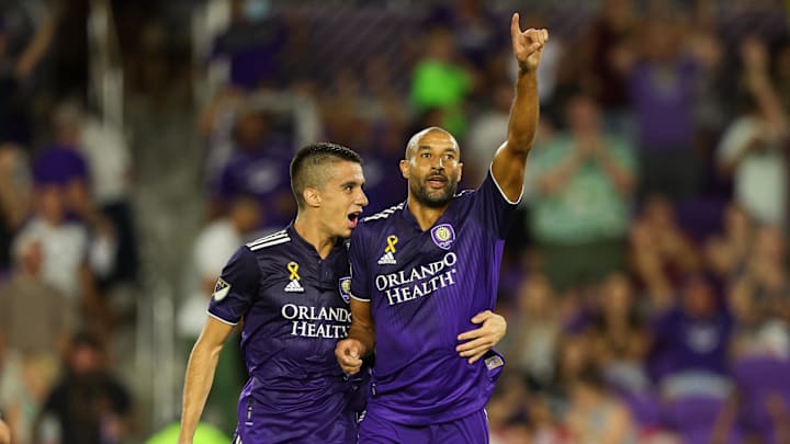 Sep 17, 2022; Orlando, Florida, USA;  Orlando City defender Joao Moutinho (4) congratulates forward
