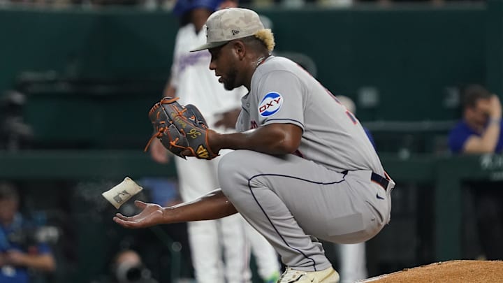 May 17, 2025; Arlington, Texas, USA; Houston Astros pitcher Ronel Blanco (56) tosses a rosin bag in the air between pitches during the third inning against the Texas Rangers at Globe Life Field.