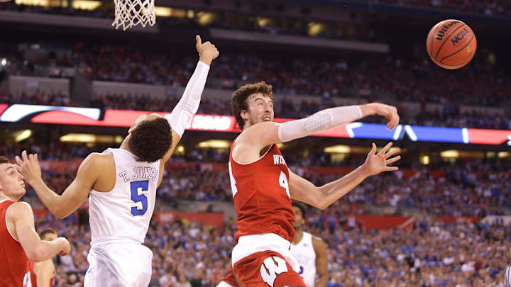 Wisconsin Badgers forward Frank Kaminsky slaps away a shot from Duke Blue Devils guard Tyus Jones during the NCAA Men's Basketball Championship game between Wisconsin and Duke at Lucas Oil Stadium in Indianapolis, Indiana, Monday, April 6, 2015.