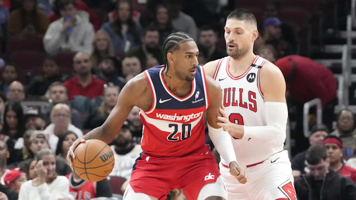 Apr 11, 2025; Chicago, Illinois, USA; Chicago Bulls center Nikola Vucevic (9) defends Washington Wizards forward Alex Sarr (20) during the first quarter at United Center. Mandatory Credit: David Banks-Imagn Images