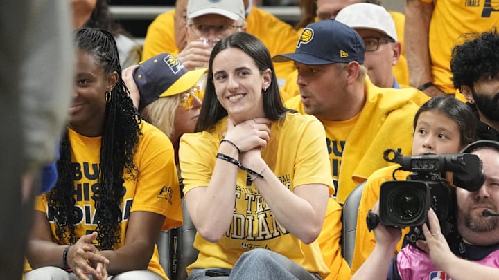 Caitlin Clark does the choke celebration early in Game 3 of the NBA Finals.