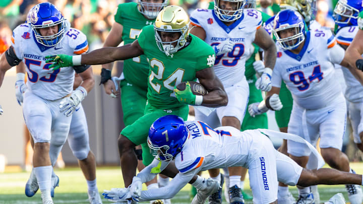Oct 4, 2025; South Bend, Indiana, USA; Notre Dame Fighting Irish running back Jadarian Price (24) tries to get past Boise State Broncos defensive back A'Marion McCoy (7) during the second half at Notre Dame Stadium. 