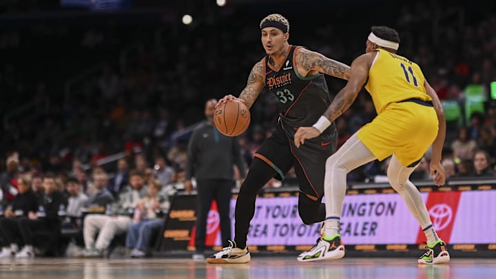 Dec 15, 2023; Washington, District of Columbia, USA;  Washington Wizards forward Kyle Kuzma (33) dribbles as Indiana Pacers forward Bruce Brown (11) defends during the game at Capital One Arena. Washington Wizards defeated Indiana Pacers 137-123.