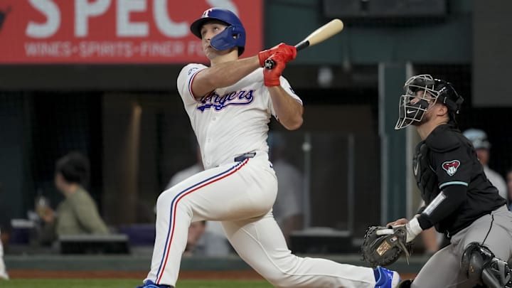 May 29, 2024; Arlington, Texas, USA; Texas Rangers left fielder Wyatt Langford (36) follows through on his RBI single against the Arizona Diamondbacks during the eighth inning at Globe Life Field. Mandatory Credit: Jim Cowsert-USA TODAY Sports