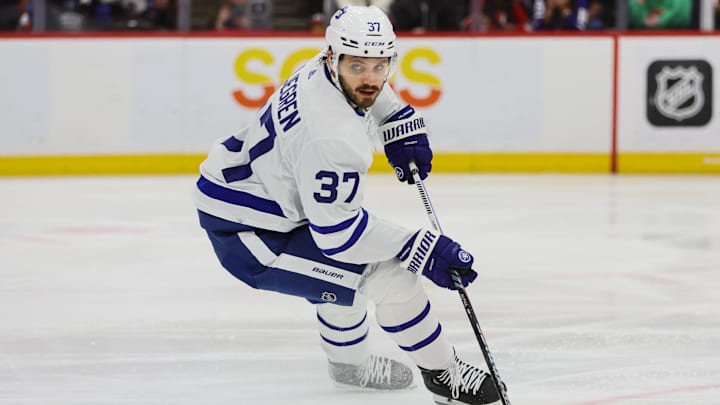 Apr 16, 2024; Sunrise, Florida, USA; Toronto Maple Leafs defenseman Timothy Liljegren (37) moves the puck against the Florida Panthers during the second period at Amerant Bank Arena. Mandatory Credit: Sam Navarro-Imagn Images
