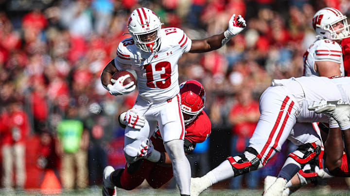 Oct 12, 2024; Piscataway, New Jersey, USA; Wisconsin Badgers running back Darrion Dupree (13) is tackled by Rutgers Scarlet Knights defensive lineman Jordan Thompson (14) during the second half at SHI Stadium. Mandatory Credit: Vincent Carchietta-Imagn Images Oct 12, 2024; Piscataway, New Jersey, USA; Wisconsin Badgers running back Darrion Dupree (13) is tackled by Rutgers Scarlet Knights defensive lineman Jordan Thompson (14) during the second half at SHI Stadium. Mandatory Credit: Vincent Carchietta-Imagn Images