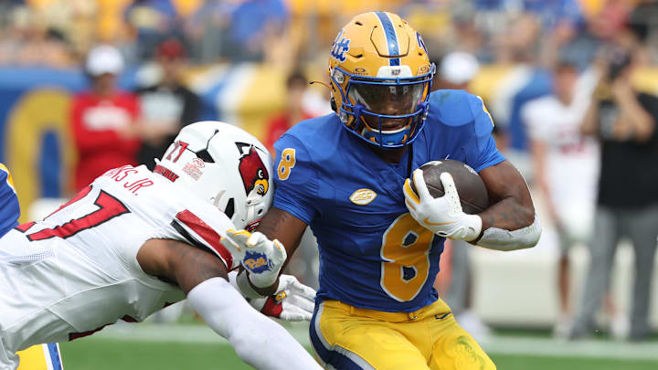 Sep 27, 2025; Pittsburgh, Pennsylvania, USA; Pittsburgh Panthers running back Juelz Goff (8) runs the ball against Louisville Cardinals defensive back JoJo Evans Jr. (27) during the first quarter at Acrisure Stadium. Mandatory Credit: Charles LeClaire-Imagn Images Sep 27, 2025; Pittsburgh, Pennsylvania, USA; Pittsburgh Panthers running back Juelz Goff (8) runs the ball against Louisville Cardinals defensive back JoJo Evans Jr. (27) during the first quarter at Acrisure Stadium. Mandatory Credit: Charles LeClaire-Imagn Images