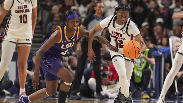 Mar 10, 2024; Greensville, SC, USA; South Carolina Gamecocks guard MiLaysia Fulwiley (12) steals the ball from LSU Lady Tigers guard Flau'jae Johnson (4) during the second half at Bon Secours Wellness Arena. Mandatory Credit: Jim Dedmon-Imagn Images