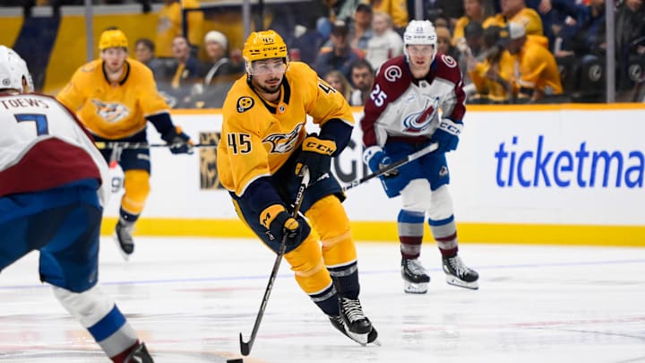 Nov 2, 2024; Nashville, Tennessee, USA;  Nashville Predators defenseman Alexandre Carrier (45) skates with the puck against the Colorado Avalanche during the third period at Bridgestone Arena. Mandatory Credit: Steve Roberts-Imagn Images
