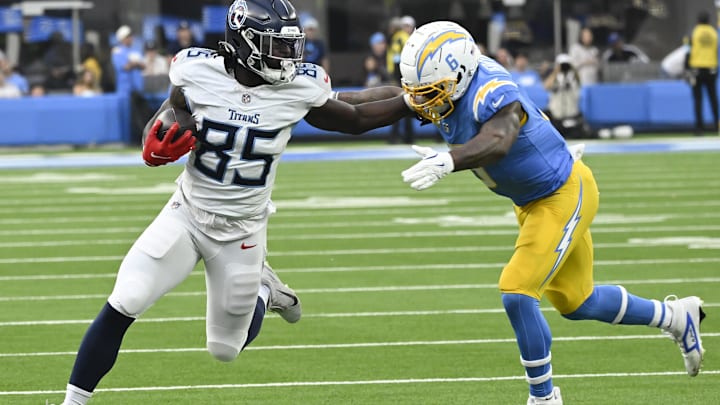 Nov 10, 2024; Inglewood, California, USA; Tennessee Titans tight end Chig Okonkwo (85) stiff arms Los Angeles Chargers linebacker Denzel Perryman (6) during the third quarter at SoFi Stadium. Mandatory Credit: Robert Hanashiro-Imagn Images Nov 10, 2024; Inglewood, California, USA; Tennessee Titans tight end Chig Okonkwo (85) stiff arms Los Angeles Chargers linebacker Denzel Perryman (6) during the third quarter at SoFi Stadium. Mandatory Credit: Robert Hanashiro-Imagn Images