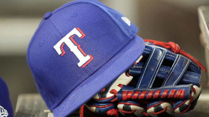 Jul 26, 2024; Toronto, Ontario, CAN; A hat and glove of a Texas Rangers player during a game against the Toronto Blue Jays at Rogers Centre.