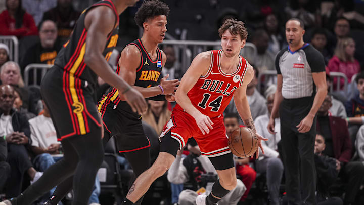Dec 21, 2025; Atlanta, Georgia, USA; Chicago Bulls forward Matas Buzelis (14) dribbles guarded by Atlanta Hawks forward Jalen Johnson (1) during the first half at State Farm Arena. Mandatory Credit: Dale Zanine-Imagn Images