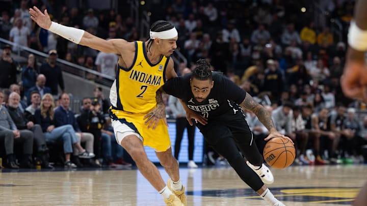 Mar 20, 2025; Indianapolis, Indiana, USA: Brooklyn Nets guard D'Angelo Russell (1) dribbles the ball while Indiana Pacers guard Andrew Nembhard (2) defends in the second half at Gainbridge Fieldhouse. Mandatory Credit: Trevor Ruszkowski-Imagn Images
