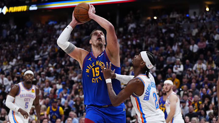 May 9, 2025; Denver, Colorado, USA; Oklahoma City Thunder guard Shai Gilgeous-Alexander (2) defends on Denver Nuggets center Nikola Jokic (15) in the second half during game three of the second round for the 2025 NBA Playoffs at Ball Arena. Mandatory Credit: Ron Chenoy-Imagn Images
