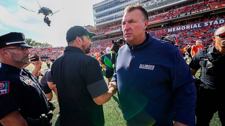 Ohio State Buckeyes head coach Ryan Day shakes hands with Illinois Fighting Illini head coach Bret Bielema following the Buckeyes' 34-16 win in the NCAA football game at Gies Memorial Stadium in Champaign on Oct. 11, 2025. Ohio State Buckeyes head coach Ryan Day shakes hands with Illinois Fighting Illini head coach Bret Bielema following the Buckeyes' 34-16 win in the NCAA football game at Gies Memorial Stadium in Champaign on Oct. 11, 2025.