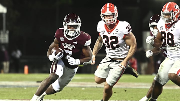 Nov 12, 2022; Starkville, Mississippi, USA;Mississippi State Bulldogs running back Jo'quavious Marks (7) runs the ball against Georgia Bulldogs linebacker Chaz Chambliss (32) during the fourth quarter at Davis Wade Stadium at Scott Field. Mandatory Credit: Matt Bush-Imagn Images