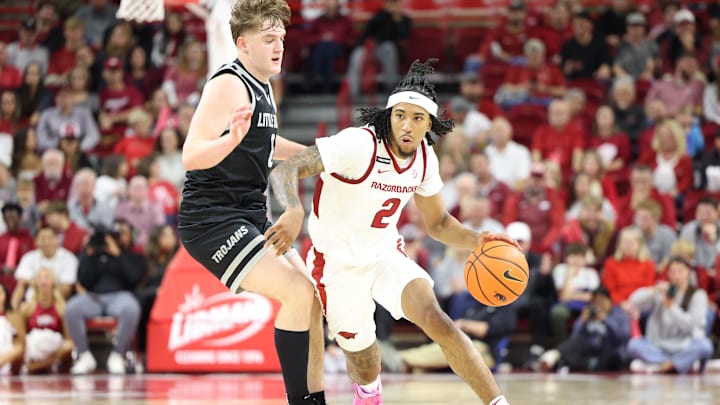 Nov 22, 2024; Fayetteville, Arkansas, USA; Arkansas Razorbacks guard Boogie Fland (2) drives against Little Rock Trojans guard Christian Hughes (0) during the second half at Bud Walton Arena. Arkansas won 79-67. Mandatory Credit: Nelson Chenault-Imagn Images