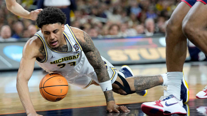 Michigan Wolverines forward Yaxel Lendeborg (23) dives for a loose ball Monday, April 6, 2026, during the National Championship game.